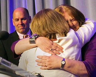 William D. Lewis The Vindicator   2019 Athena winner Dr. Tammy King, right, hugs Dr. Betty Jo Licata, MC of program. At left is James Dignan, CEO of regional Chamber.