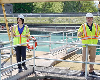 Jennifer Johnson, left, area manager at Aqua Ohio, and George Ginnis, project manager at Aqua Ohio, discuss progress on renovations near the sedimentation basins at the Aqua Ohio water plant in Poland. The sedimentation basins will be replaced by new solid contact units. 