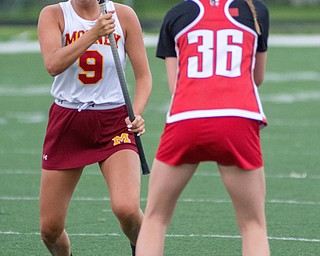 Lexi Saunders of Cardinal Mooney looks to attack as Tara Santoro of Canfield stands her ground in a Division II tournament game at Don Bucci Field on Thursday..