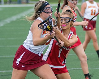 Grace Ramun (1) of Canfield attempts to keep Katie Enright of Cardinal Mooney from the cage in a Division II tournament game at Don Bucci Field on Thursday
