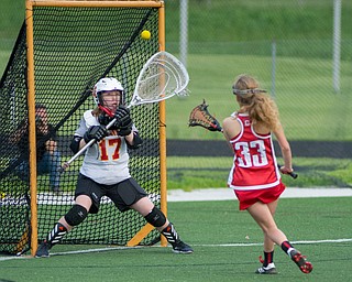 Cardinal Mooney goalkeeper Annie Driscoll attempts to stop a shot from Paige Christoff of Canfield in a Division II tournament game at Don Bucci Field on Thursday