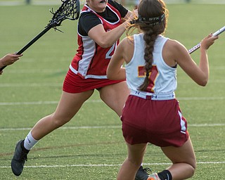 Isabella Kelty of Canfield drives in for a goal as Lia Fecko of Cardinal Mooney defends in a Division II tournament game at Don Bucci Field on Thursday..￼.