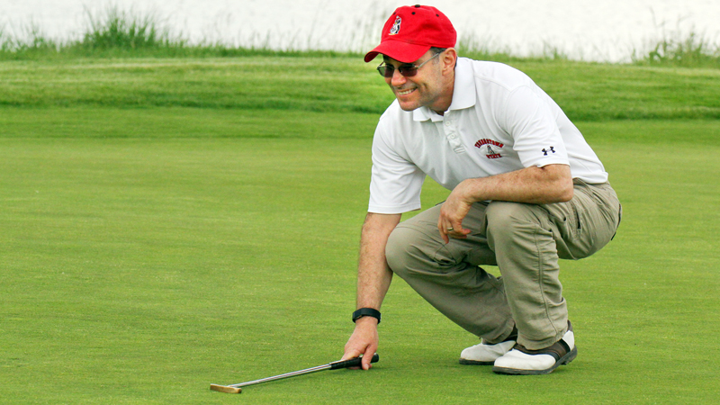 John Hazy lines up a putt at Firestone Farms in Columbiana during Greatest Golfer of the Valley action on Friday.