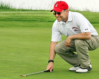 John Hazy lines up a putt at Firestone Farms in Columbiana during Greatest Golfer of the Valley action on Friday.