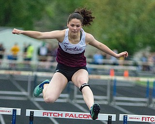 Kaylin Burkey clears a hurdle in the 300-meter hurdles at the Division I District Track and Field Meet at Greenwood Chevrolet Falcon Stadium on Friday night