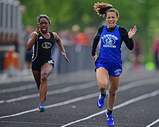 NEW SPRINGFIELD, OHIO - MAY 17, 2019: Lisbon's Izzy Perez races to the finish line ahead of Valley Christian's Kennedy Tucker during the girls 100 meter dash, Friday night during the Division III District Track Meet at Springfield High School. DAVID DERMER | THE VINDICATOR