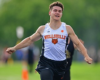 NEW SPRINGFIELD, OHIO - MAY 17, 2019: Wellsville's Justin Wright crosses the finish line during the boys 100 meter dash, Friday night during the Division III District Track Meet at Springfield High School. DAVID DERMER | THE VINDICATOR