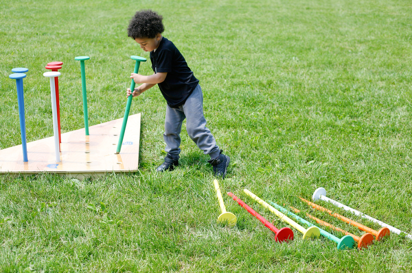 Noah Axel, 3, of Poland, plays with an oversized peg set at Kids to Parks Day at Ipe Field on Saturday afternoon. EMILY MATTHEWS | THE VINDICATOR
