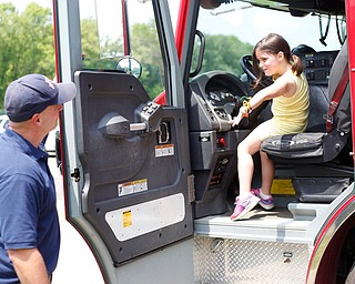 Mya Niznik, 6, of Struthers, tries to convince Lt. Bill Palma to let her drive the Youngstown firetruck at Kids to Parks Day at Ipe Field on Saturday afternoon. EMILY MATTHEWS | THE VINDICATOR