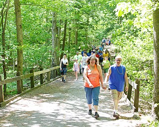 Robin Holliday, left, and Deroy Holliday, both of New Castle, Pa., walk in the 20th annual Mahoning/Trumbull Great Strides cystic fibrosis walk at Boardman Park on Sunday afternoon. EMILY MATTHEWS | THE VINDICATOR