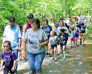 Madison Himes, 6, of New Middletown, who has cystic fibrosis, walks with, from left, her uncle Aaron Mehocic, cousin James Holliday, both of New Castle, Pa., and grandmother Claudia Mehocic, of Pulaski, in the 20th annual Mahoning/Trumbull Great Strides cystic fibrosis walk at Boardman Park on Sunday afternoon. EMILY MATTHEWS | THE VINDICATOR