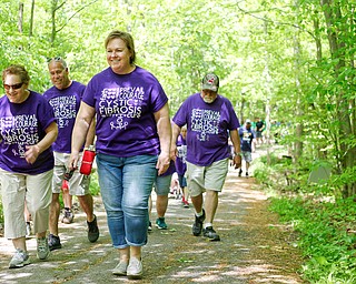 From left, Chris Davis, of Struthers, Brad Davis, of Struthers, Cathy Cunningham, of Elyria, and Paul Schmidt, of Canfield, walk for Schmidt's grandson Colt, who has cystic fibrosis, in the 20th annual Mahoning/Trumbull Great Strides cystic fibrosis walk at Boardman Park on Sunday afternoon. EMILY MATTHEWS | THE VINDICATOR