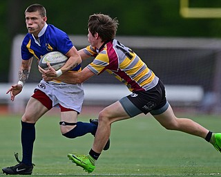 AVON LAKE, OHIO - MAY 19, 2019: Youngstown East's Samuel Cartagena runs with he ball away from an Avon Lake defender during the first half of their game, Sunday afternoon at Avon Lake High School. DAVID DERMER | THE VINDICATOR