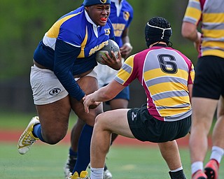 AVON LAKE, OHIO - MAY 19, 2019: Youngstown East's XXXX runs the ball while being pressured by a Avon Lake defender during the first half of their game, Sunday afternoon at Avon Lake High School. DAVID DERMER | THE VINDICATOR