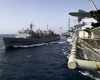 In this Sunday photo released by the U.S. Navy, the fast combat support ship USNS Arctic transports cargo to the Nimitz-class aircraft carrier USS Abraham Lincoln during a replenishment-at-sea in the Arabian Sea.  