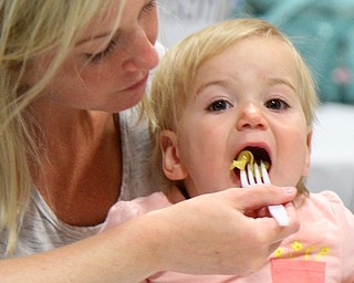Calie Coppola and her daughter Gia, 1, enjoy a meal during this year’s Taste of Stuthers event at St. Nicholas Hall.