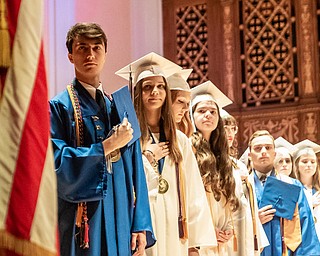 DIANNA OATRIDGE | THE VINDICATOR  The valedictiorians of Hubbard High School's Class of 2019 salute the flag during the playing of the National Anthem at their commencement ceremony at Stambaugh Auditorium on Wednesday.