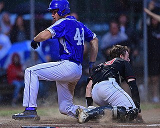 STRUTHERS, OHIO - MAY 22, 2019: Poland's Zachary Yaskulka scores a run beating a tag from Canfield's Danny Beistel in the second inning of their OHSAA Tournament game, Wednesday night at Cene Park. DAVID DERMER | THE VINDICATOR