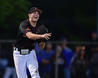 STRUTHERS, OHIO - MAY 22, 2019: Canfield's Ricky Havrilla throws to first to get out Poland's Ian Lu in the second inning of their OHSAA Tournament game, Wednesday night at Cene Park. DAVID DERMER | THE VINDICATOR