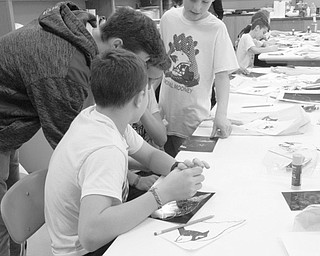Neighbors | Jessica Harker .Jack Pepperney, a student at Mooney high school, assisted middle school students in art class March 29 for the school's annual fifth- and sixth-grade day.