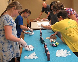 Neighbors | Jessica Harker.Children decorated pillow cases with tie dye April 9 at the Poland library.