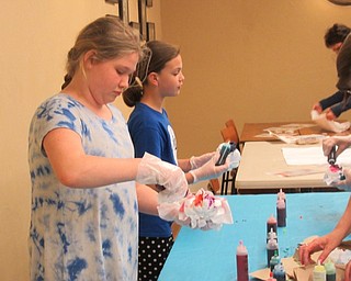 Neighbors | Jessica Harker.Children used different colored dye to transform pillow cases April 9 at the Poland library's Tie Dye party.