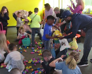 Neighbors | Jessica Harker .Children raced to gather eggs into their baskets during the First American Loan annual egg hunt April 20 at Austintown Bounce.
