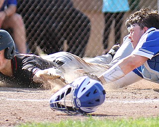 Canfield;'s Brayden Beck (9) scores as Poland catcher MJ Farber (25) tries to make the tag during Thursday's action at Cene field.