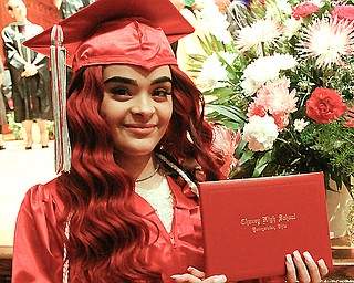 Chaney High School graduate Tamara Rios, who will enter the Army, shows off her diploma during Chaney’s commencement at Stambaugh Auditorium Thursday afternoon. 