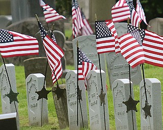 American flags, in celebration of Memorial Day, wave in the wind at Oak Hill Cemetery in Youngstown where fallen servicemen are interred.