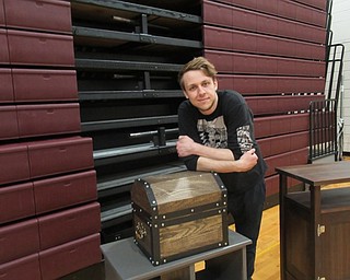 Neighbors | Jessica Harker.Sam Larkin posed next to the chest he created that was on display May 17 at Boardman High School's Visual Arts Show.