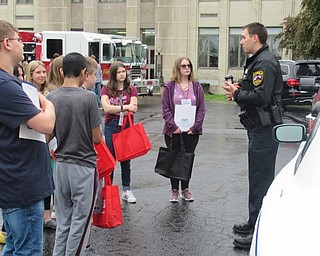 Neighbors | Jessica Harker.Canfield Police Officers were present at Canfield Middle School's annual Career Day May 13, showing students the officer's cruiser and explaining their job.