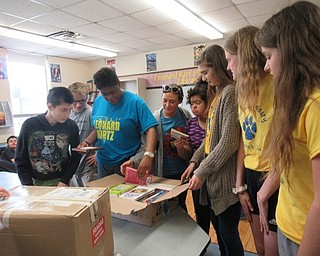 Neighbors | Jessica Harker.Leonard Kirtz students and Poland Seminary High Schools students unpack books that the Poland Interact Club donated to the school May 17.
