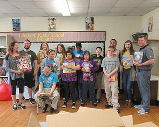 Neighbors | Jessica Harker.Poland Interact Club members and advisor posed with Leonard Kirtz students and staff with the books the club donated to the school May 17.