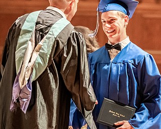 DIANNA OATRIDGE | THE VINDICATOR  Zakary Ziglear shakes the hand of Superintendent Raymond Soloman after receiving his diploma at the Class of 2019 Hubbard High School Commencement ceremony held at Stambaugh Auditorium on Wednesday night.