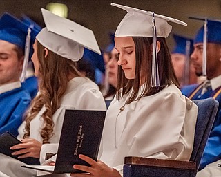 DIANNA OATRIDGE | THE VINDICATOR  Amber Benner looks at her diploma during the Class of 2019 Hubbard High School Commencement ceremony held at Stambaugh Auditorium on Wednesday night.