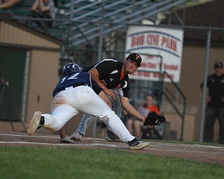 Shane Eynon of Springfield gets ready to tag out Alex Hernandez (12) of Warren JFK as he attempted to slide into home during the district championship matchup at Cene Park in Struthers on Thursday night.   Dustin Livesay  |  The Vindicator  5/23/19  Cene Park.