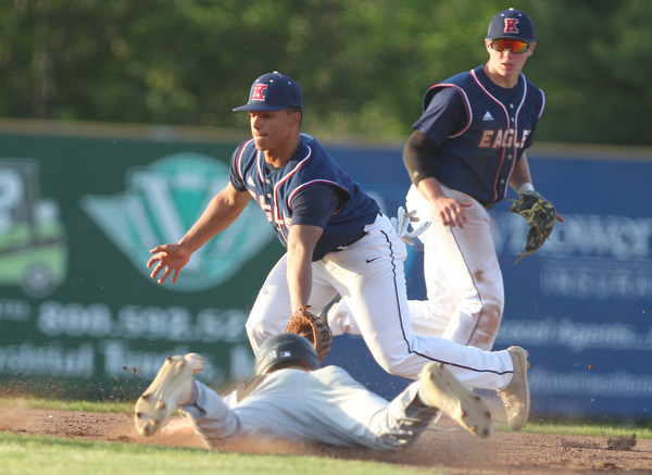 Warren JFK’s Jordan Edmondson (1) tries to tag out a sliding Nick Slike (2) during the district championship matchup at Cene Park in Struthers on Thursday night.   Dustin Livesay  |  The Vindicator  5/23/19  Cene Park.