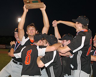 Shane Eynon of Springfield is surrounded by his teammatres as he holds up the District Champion trophy after he had a one out walk off single in the bottom of the seventh inning to defeat Warren JFK at Cene Park in Struthers on Thursday night.   Dustin Livesay  |  The Vindicator  5/23/19  Cene Park.