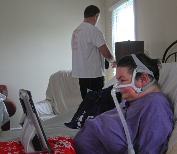 William D. Lewis the vindicator  Brian looks out a window as Christine looks at her computer 5-1-19.