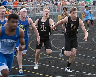 Crestview's Powell hands the baton to Huff in the boys 800 relay during the Division III regional track meet at Massillon Perry High School on Friday. EMILY MATTHEWS | THE VINDICATOR