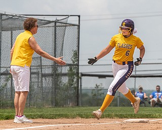 DIANNA OATRIDGE | THE VINDICATOR  Champion's Allison Smith (6) reaches for Coach Cheryl Weaver's hand as she rounds third and heads home after hitting a solo home run during the Division III Regional Final against Northwestern on Saturday in Massillon.