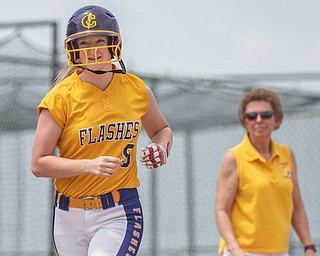 DIANNA OATRIDGE | THE VINDICATOR  Champion's Cassidy Shaffer smiles as she heads home past Coach Cheryl Weaver after hitting a solo home run during their Division III Regional Final game versus Northwestern on Saturday in Massillon. Champion won 3-0.