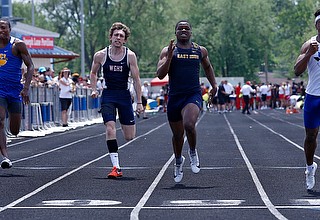 AUSTINTOWN, OHIO - May 24, 2019: Track & Field  D2 Region at Austintown-Fitch High School. .Boys 100m. Youngstown East's Giovanni Washington (center) and Girard's Nicolas Malito (far left) take 2nd and 3rd places, respectively,to qualify for the state meet, Photo by MICHAEL G. TAYLOR | THE VINDICATOR