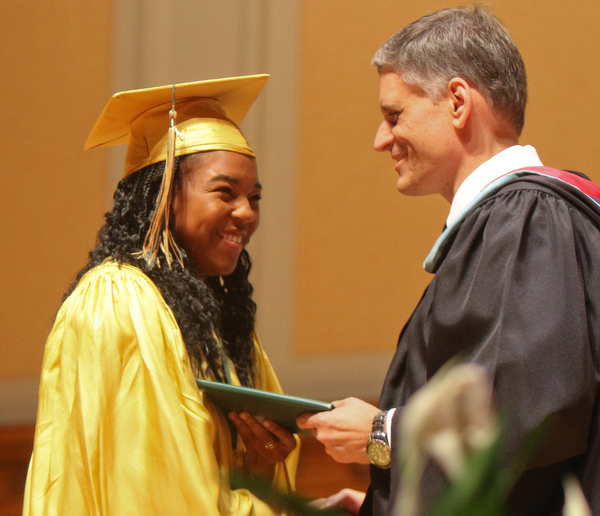 William D. Lewis the Vindicator Ursuline grad Dayshanette Harris is presented her diploma by principal Matthew Sammartino during commencement 5-26 at Stambaugh.