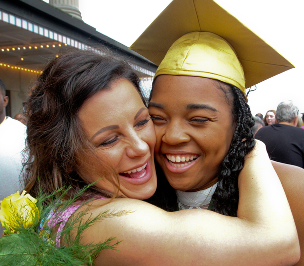William D. Lewis the Vindicator Ursuline grad Dayshanette Harris is hugged by Kristen Occhibove after commencement 5-26 at Stambaugh.