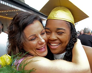 William D. Lewis the Vindicator Ursuline grad Dayshanette Harris is hugged by Kristen Occhibove after commencement 5-26 at Stambaugh.