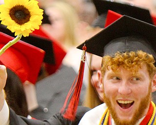 Girard graduate Sal DiVencenzo, class vice president holds a sunflower, which was class flower, during Sunday's commencement.