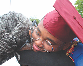 Mooney graduate Andre Carter gets a hug from his aunt Cynthia Carter after graduation.