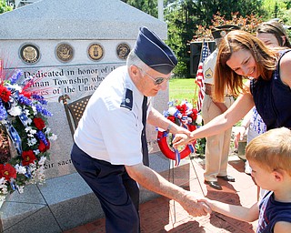 William D. Lewis The Vindicator Lt. Colonel Bill Moss USAF (Ret.) of Poland shakes the hand of 5 year old Jude Morgan. At right is Jude's mother Ronnie Morgan, they are from Canfield. More than 250 people attended a Memorial Day ceremony in Boardman Park Monday.